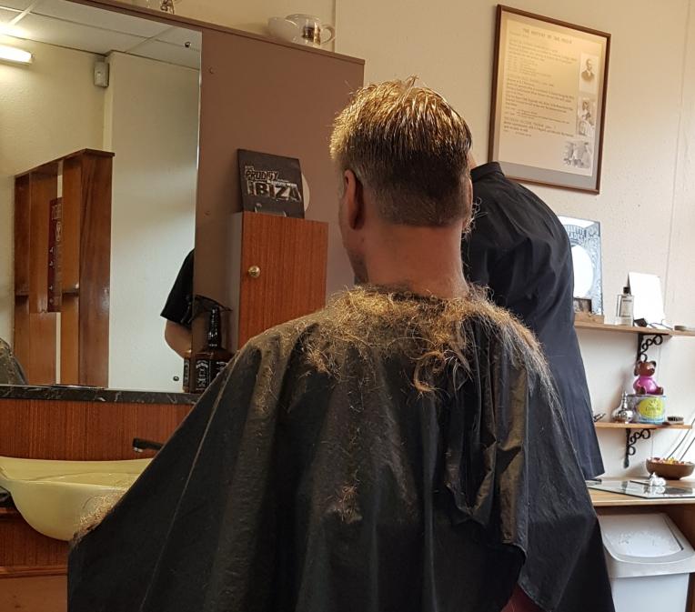 back of man in barber's chair