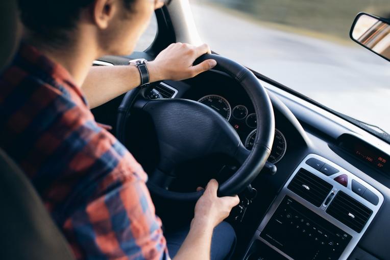 young person steering car