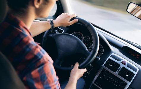 young person steering car